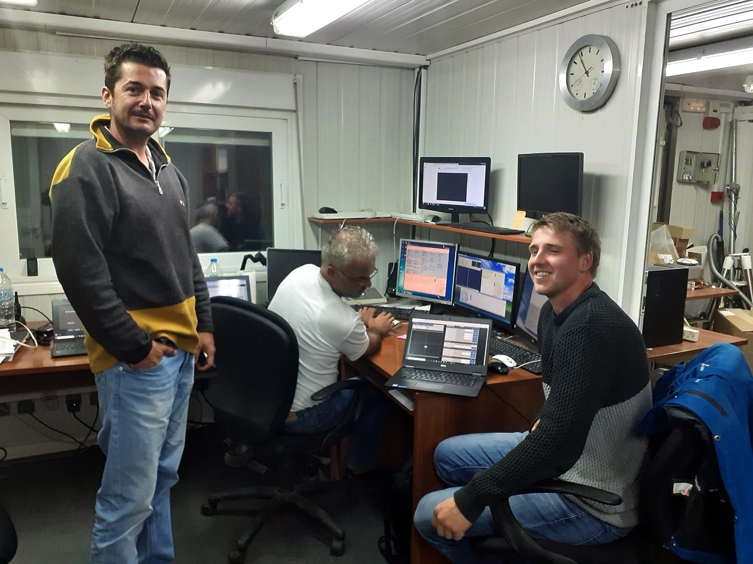 Members of the ScyLight team (Alexis Gourzelas, Ioannis Alikakos and Donatas Miklusis) with the first light image displayed on the screen of the laptop: a star very near the center of the image.
